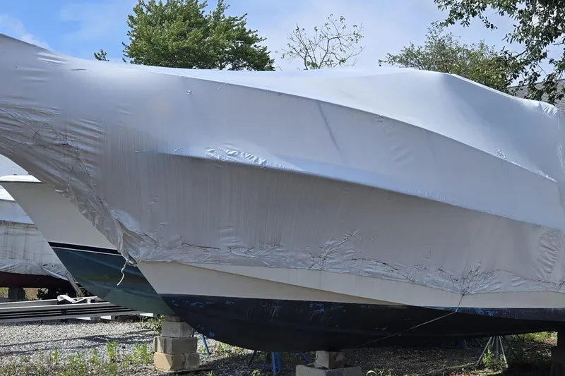 Slide: The Image of 2001 Parker 2520 Modified Vee Sport Cabin boat covered in protective wrap. - 17