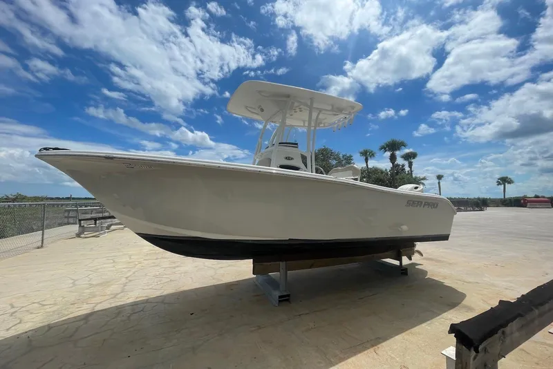The Image of 2016 Sea Pro 219 Center Console boat on display under a bright blue sky. - 0