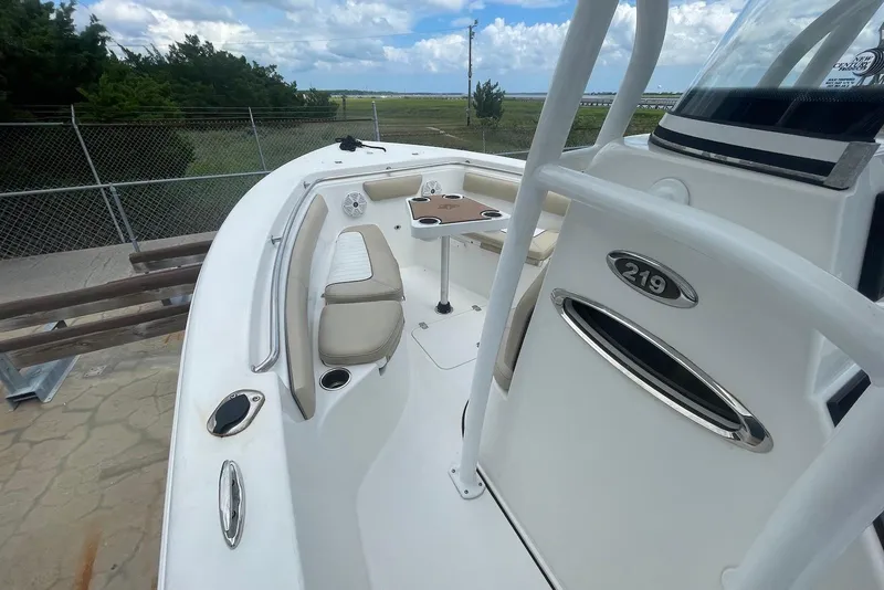 Slide: The Image of 2016 Sea Pro 219 Center Console boat with seating and table, docked outdoors. - 3