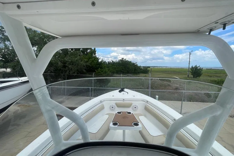 Slide: The Image of 2016 Sea Pro 219 Center Console boat with spacious seating and scenic outdoor view. - 4