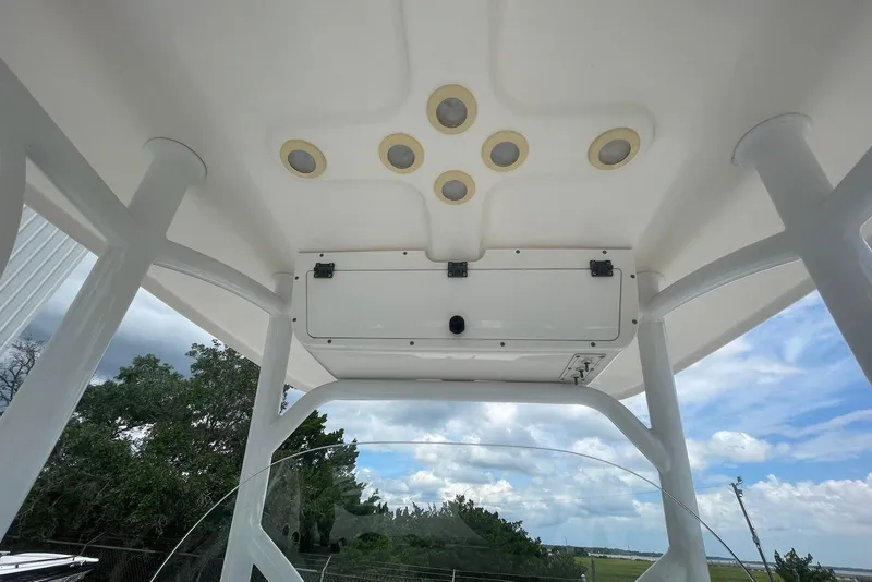 Slide: The Image of 2016 Sea Pro 219 Center Console boat's overhead view with built-in lights and clear sky. - 8