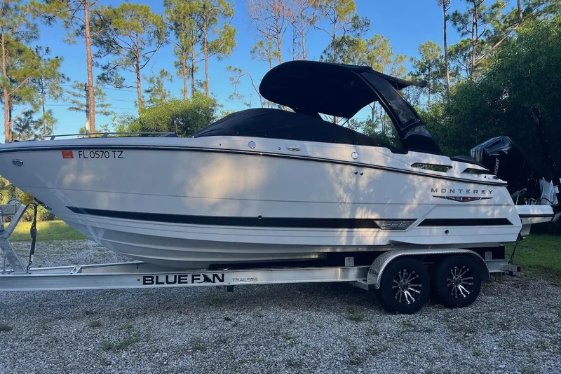 The Image of 2025 Monterey 255 Super Sport boat on trailer, parked outdoors with trees in background. - 0