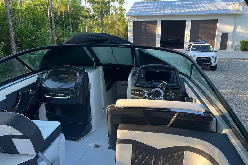 Slide: The Image of 2025 Monterey 255 Super Sport boat interior with modern dashboard and seating. - 14