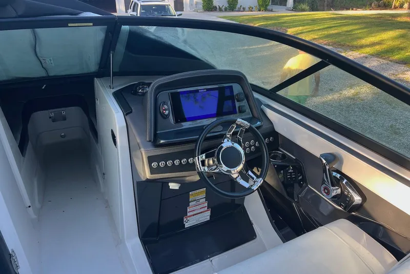 Slide: The Image of 2025 Monterey 255 Super Sport boat interior with modern dashboard and steering wheel. - 15