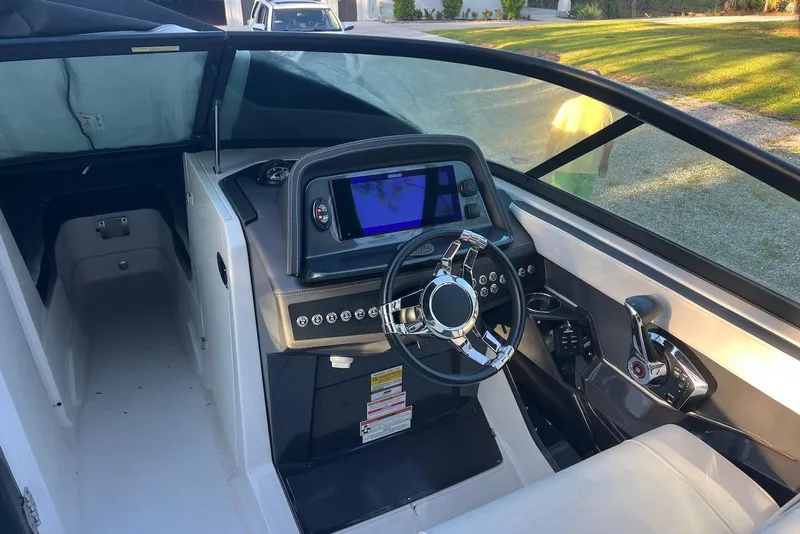 Slide: The Image of 2025 Monterey 255 Super Sport boat cockpit with modern steering and control panel. - 16