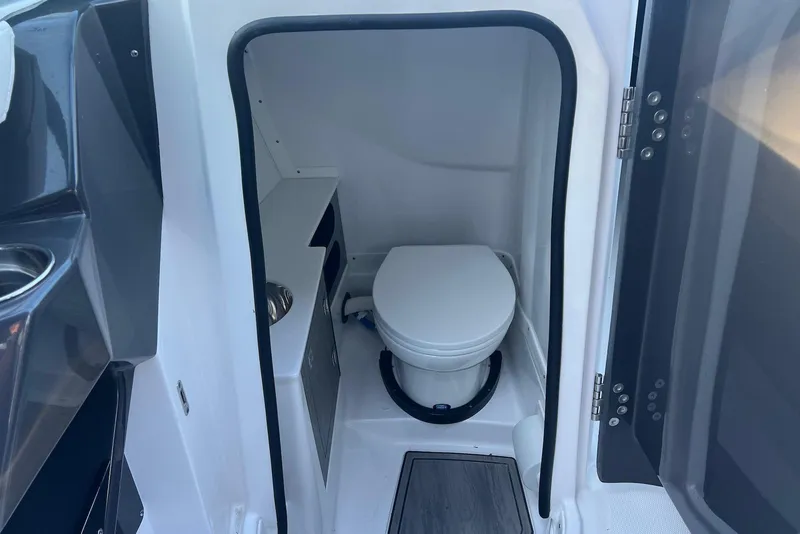 Slide: The Image of 2025 Monterey 255 Super Sport boat interior with compact marine toilet. - 17