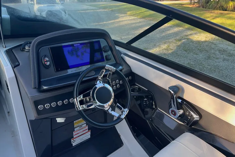 Slide: The Image of 2025 Monterey 255 Super Sport boat dashboard with steering wheel and navigation display. - 9