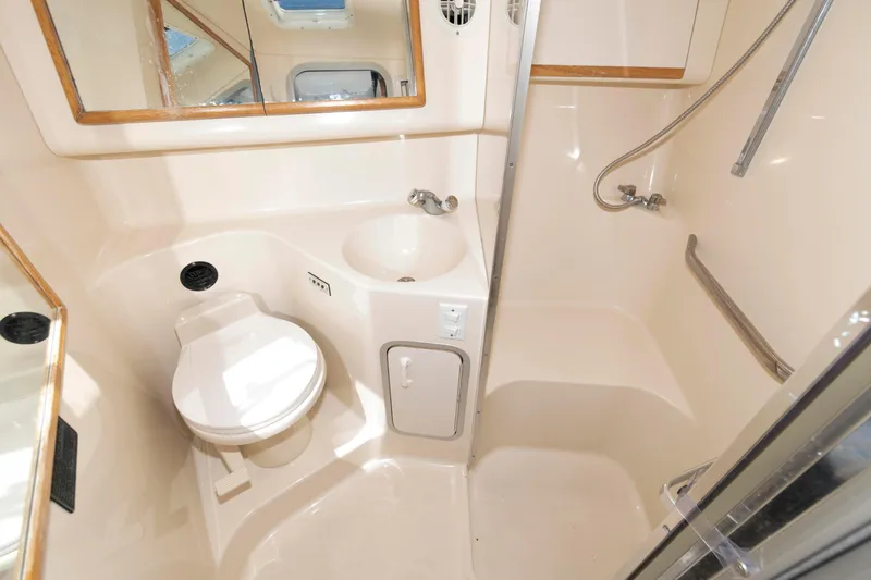 Slide: The Image of 1995 Sea Ray 370 Sundancer cabin with striped bedding and cozy interior design. - 13