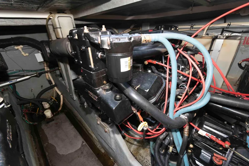 Slide: The Image of Engine compartment of a 1995 Sea Ray 370 Sundancer with visible wiring and components. - 16