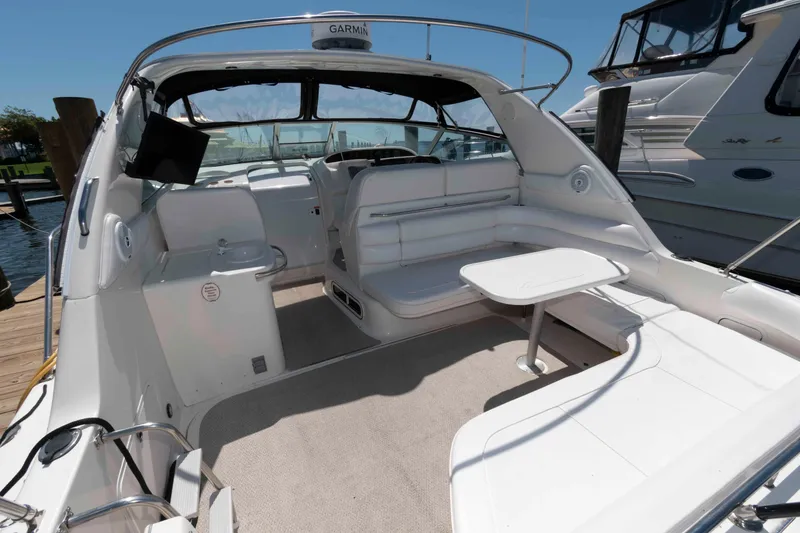 Slide: The Image of 1995 Sea Ray 370 Sundancer yacht docked at marina under blue sky. - 2