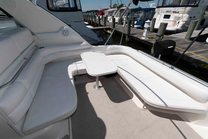 Slide: The Image of 1995 Sea Ray 370 Sundancer boat docked under a partly cloudy sky. - 3