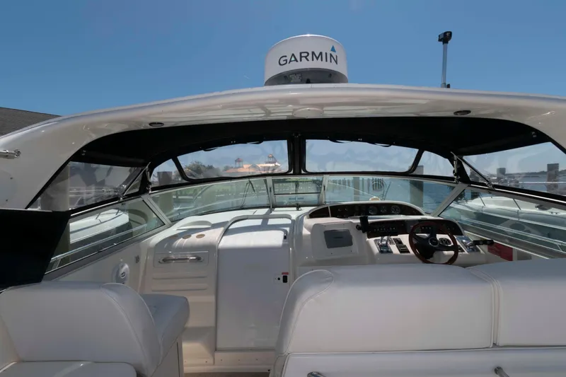 Slide: The Image of 1995 Sea Ray 370 Sundancer boat interior with seating and table, docked at marina. - 4