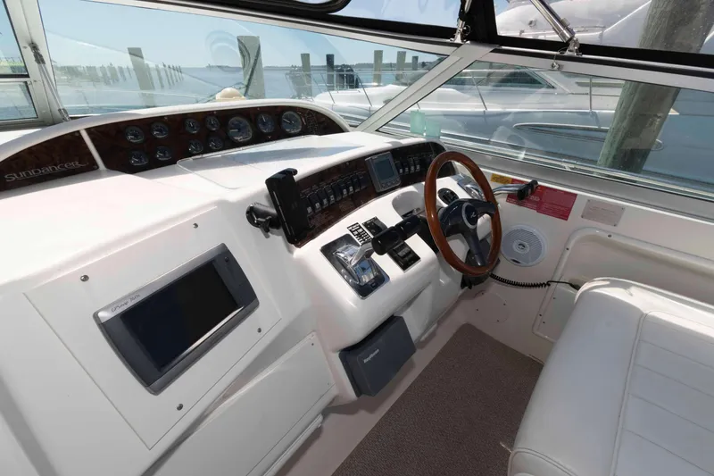 Slide: The Image of Interior view of a 1995 Sea Ray 370 Sundancer boat cockpit with Garmin equipment. - 6