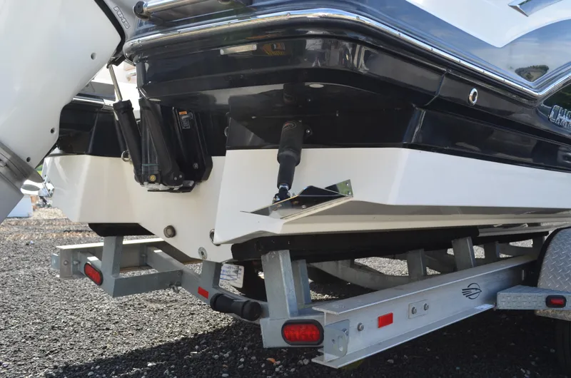 Slide: The Image of Rear view of 2018 Chaparral 250 Suncoast boat on trailer, showcasing hull and outboard motor. - 10