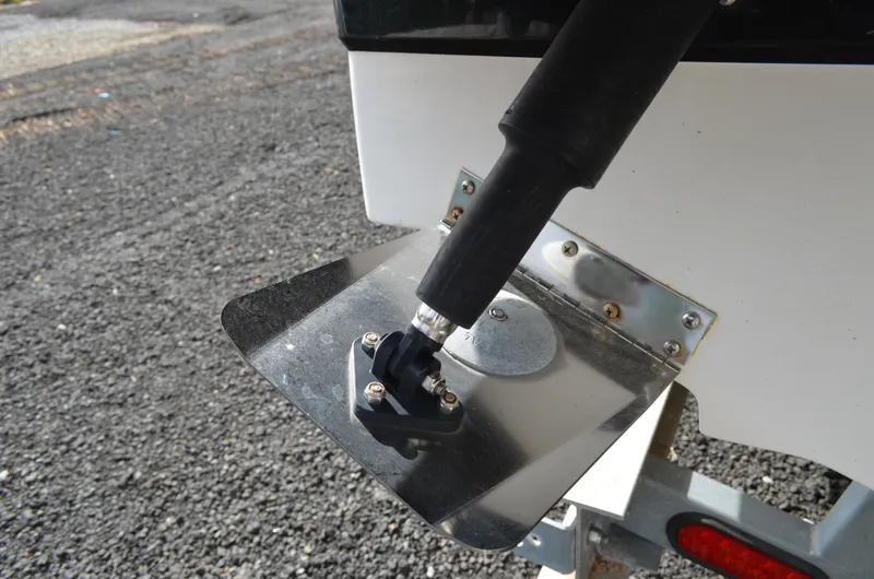 Slide: The Image of 2018 Chaparral 250 Suncoast boat trim tab detail on asphalt surface. - 11