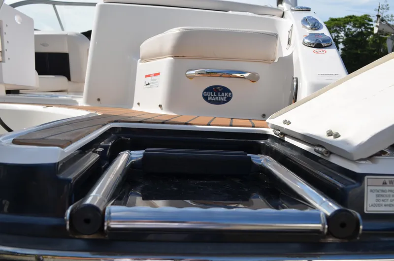 Slide: The Image of 2018 Chaparral 250 Suncoast boat with swim platform and ladder, Gull Lake Marine branding. - 16