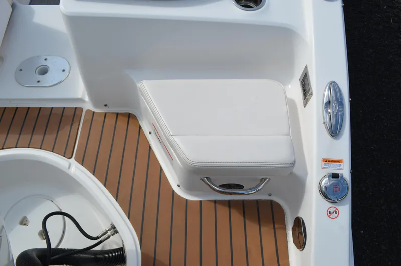 Slide: The Image of 2018 Chaparral 250 Suncoast boat interior with white seating and teak flooring. - 17
