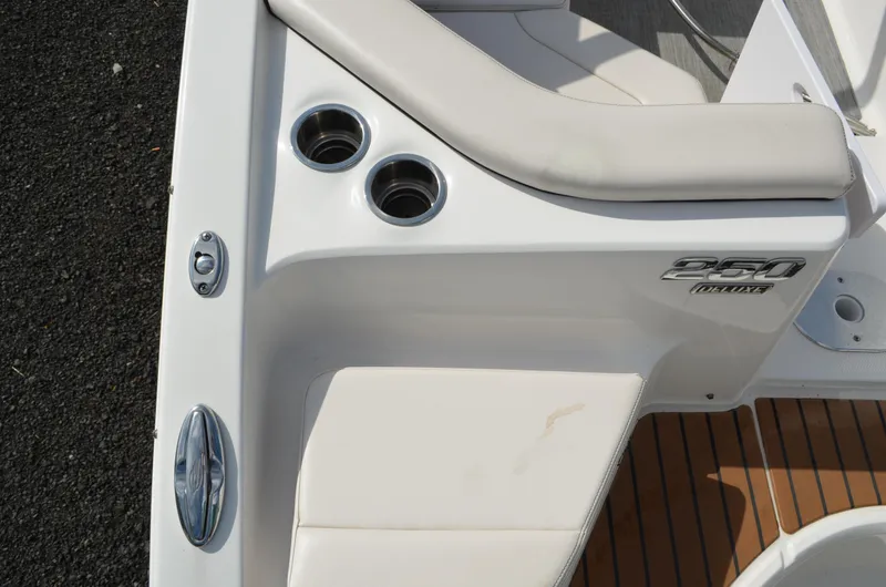 Slide: The Image of 2018 Chaparral 250 Suncoast boat interior with cup holders and seating. - 20