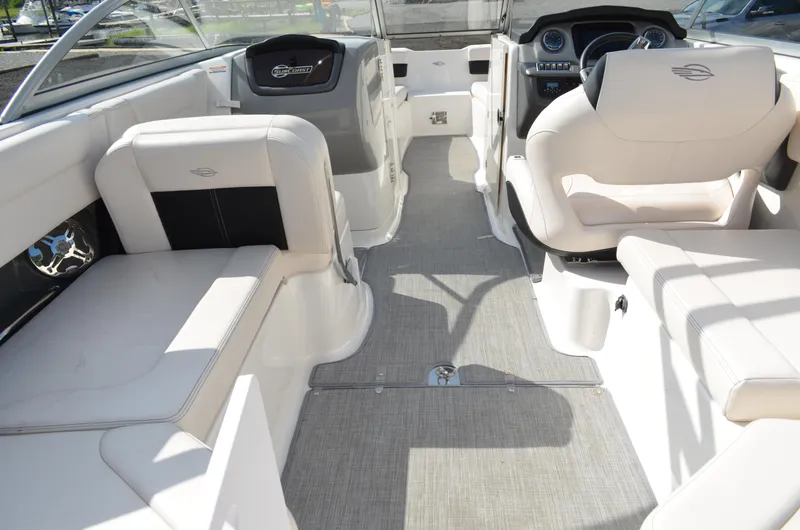 Slide: The Image of 2018 Chaparral 250 Suncoast boat interior with white seating and modern dashboard. - 21