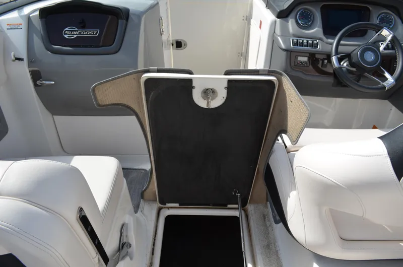 Slide: The Image of 2018 Chaparral 250 Suncoast boat interior with steering wheel and seating area. - 22