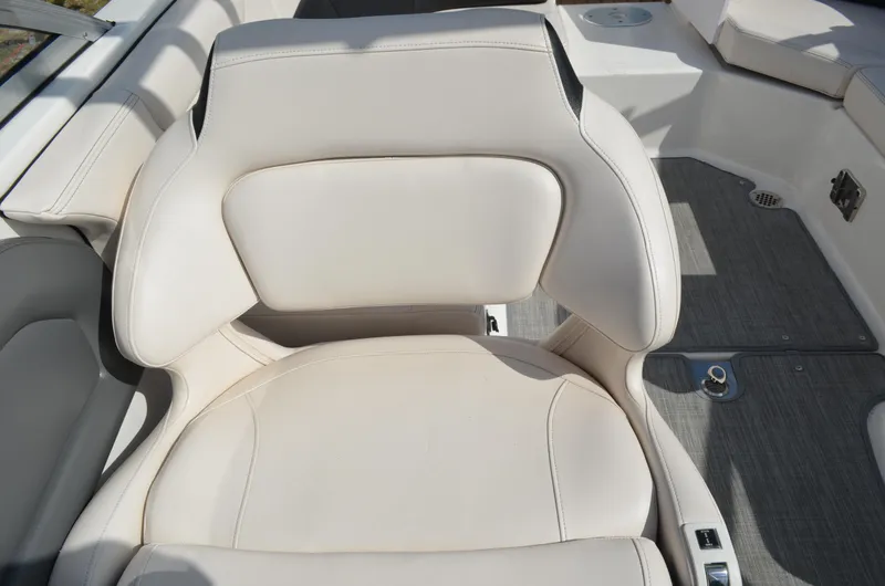 Slide: The Image of 2018 Chaparral 250 Suncoast boat seat, white leather, modern design, spacious deck area. - 26