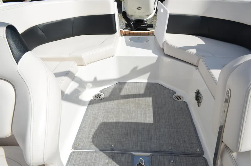 Slide: The Image of 2018 Chaparral 250 Suncoast boat interior with white seating and gray flooring. - 27