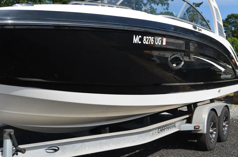 Slide: The Image of 2018 Chaparral 250 Suncoast boat on trailer, black and white exterior, side view. - 3
