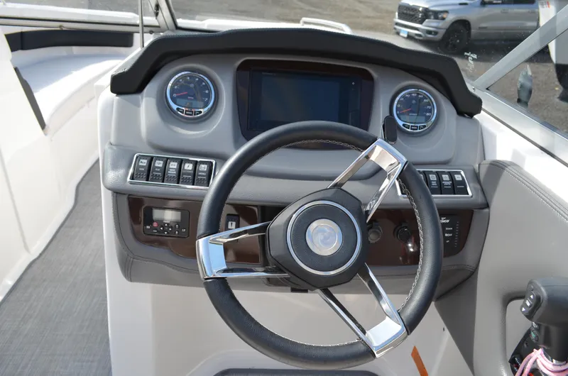 Slide: The Image of 2018 Chaparral 250 Suncoast boat dashboard with steering wheel and gauges. - 30