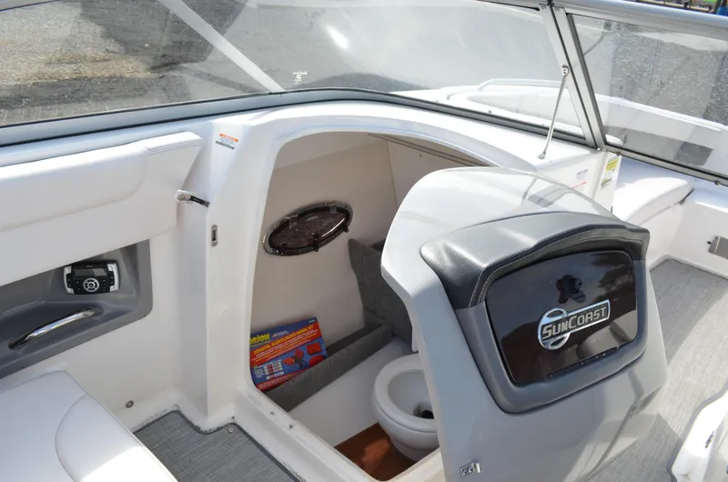 Slide: The Image of 2018 Chaparral 250 Suncoast boat interior with compact cabin and Suncoast branding. - 32