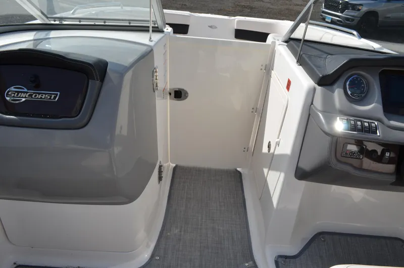 Slide: The Image of 2018 Chaparral 250 Suncoast boat interior, featuring dashboard and seating area. - 35