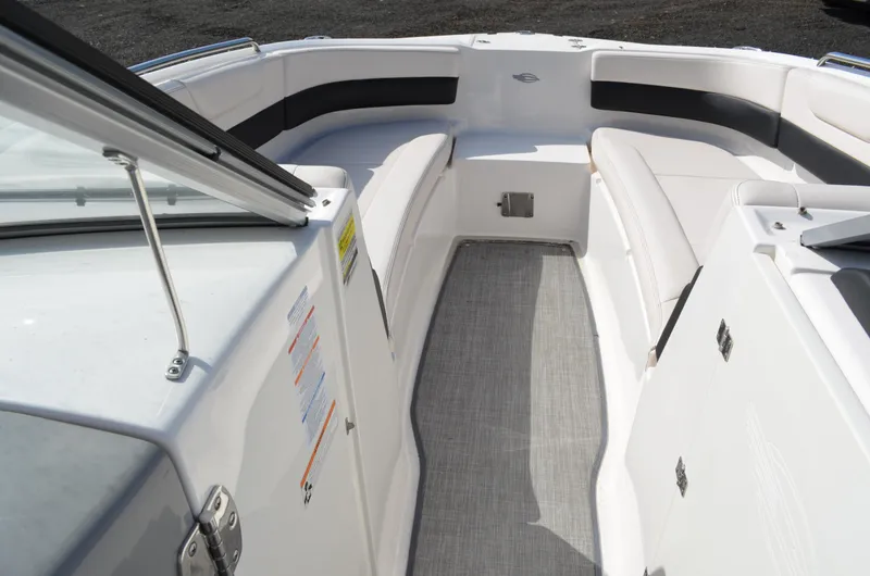 Slide: The Image of 2018 Chaparral 250 Suncoast boat interior with white seating and gray flooring. - 36