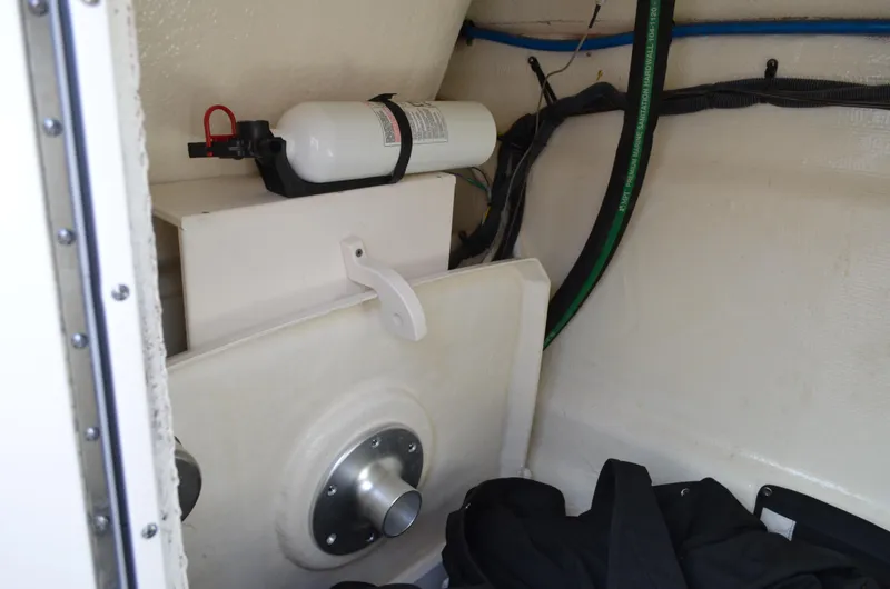 Slide: The Image of Interior of 2018 Chaparral 250 Suncoast boat showing storage compartment and fire extinguisher. - 38