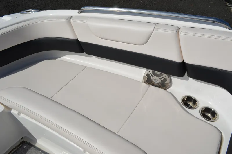 Slide: The Image of 2018 Chaparral 250 Suncoast boat interior with cushioned seating and cup holders. - 39