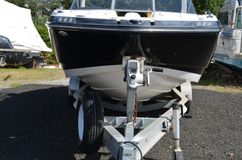 Slide: The Image of 2018 Chaparral 250 Suncoast boat on trailer, front view, outdoors. - 4