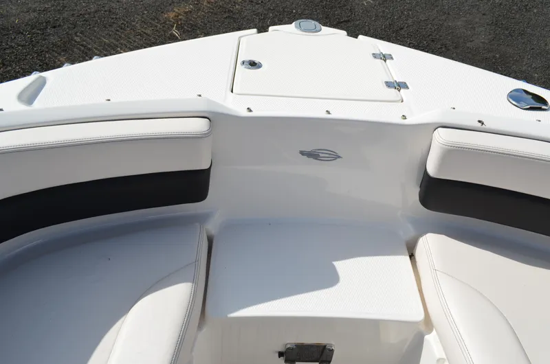 Slide: The Image of 2018 Chaparral 250 Suncoast boat interior with white seating and storage compartment. - 41