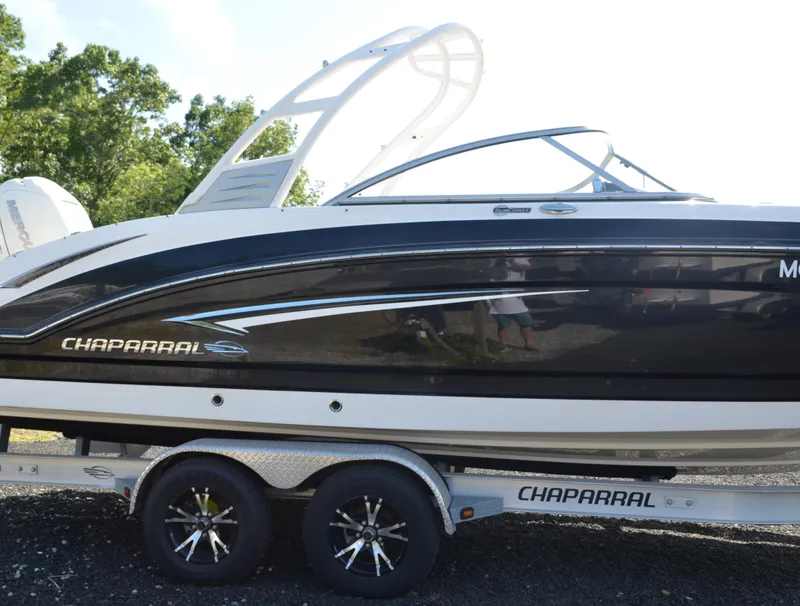 Slide: The Image of 2018 Chaparral 250 Suncoast boat on trailer, side view with sleek design. - 5
