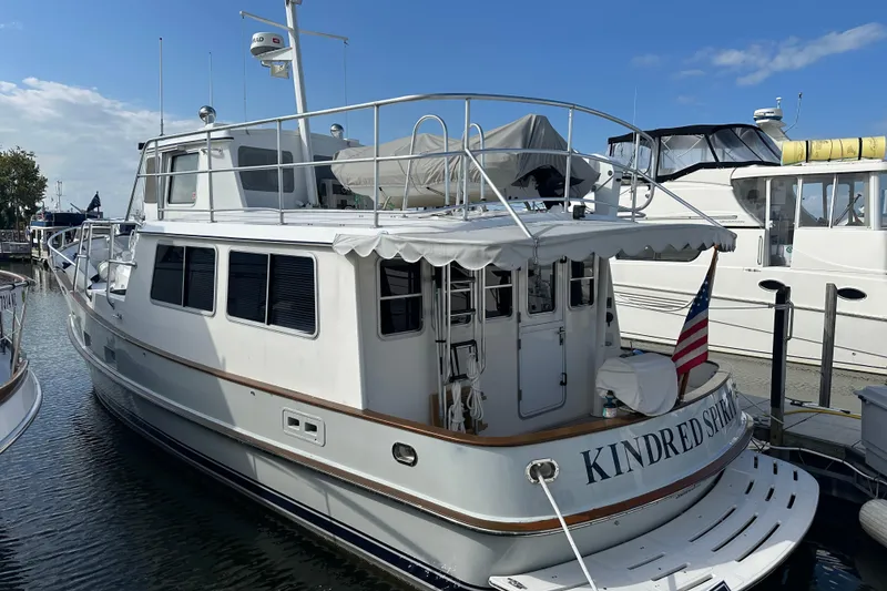 Slide: The Image of Cherubini Independence 45 yacht, 2001 model, docked with American flag, sunny day. - 95