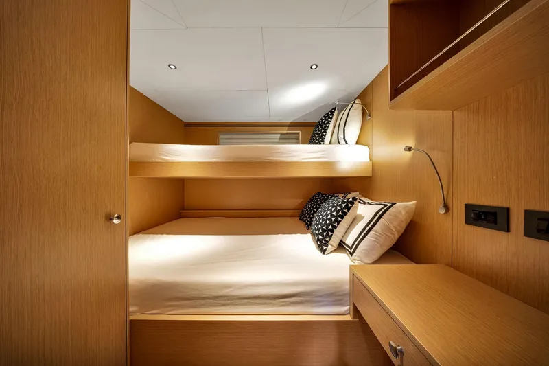 Slide: The Image of Interior of 2021 Sirena 88 yacht cabin with bunk beds and modern wood finish. - 140