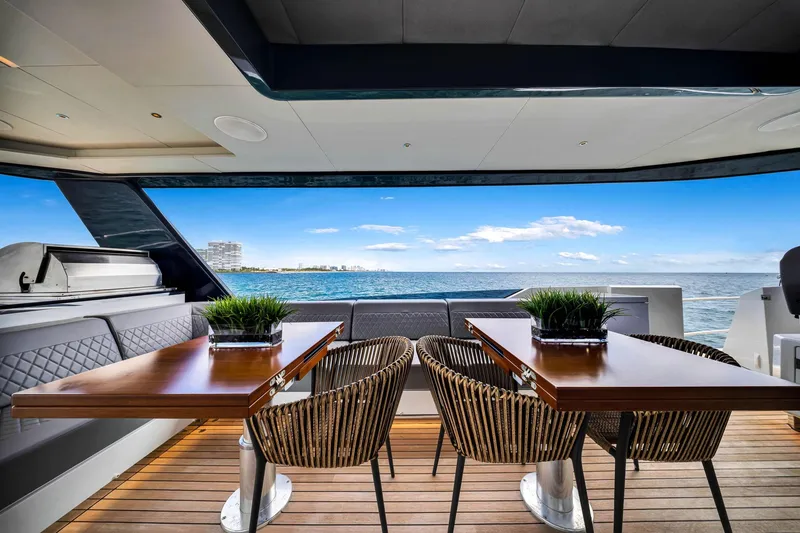 Slide: The Image of Luxurious Sirena 88 yacht deck with elegant seating, wooden tables, and ocean view, 2021 model. - 18