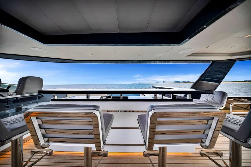Slide: The Image of Luxury Sirena 88 yacht interior, 2021 model, featuring elegant seating and ocean view. - 21