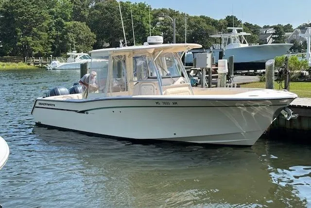 The Image of 2011 Grady-White Canyon 306 boat docked in a serene marina setting. - 0