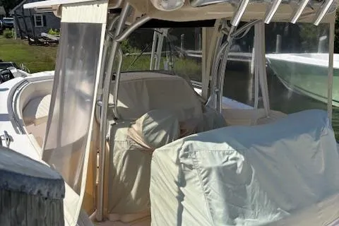 Slide: The Image of 2011 Grady-White Canyon 306 boat with covered seating and protective enclosures. - 2