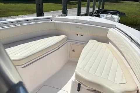 Slide: The Image of 2011 Grady-White Canyon 306 boat interior with cushioned seating and storage. - 4