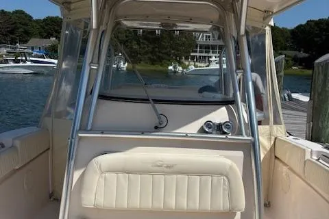Slide: The Image of 2011 Grady-White Canyon 306 boat interior with helm, docked by the water. - 7