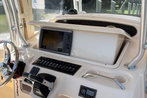 Slide: The Image of 2011 Grady-White Canyon 306 boat dashboard with navigation equipment and controls. - 8