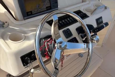 Slide: The Image of 2011 Grady-White Canyon 306 boat steering wheel and control panel. - 9