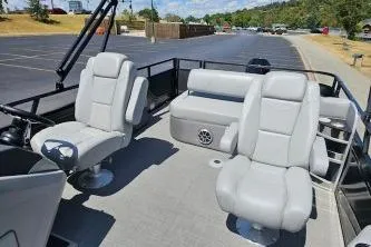 Slide: The Image of 2024 Regency 250 DL3 boat interior with plush seating in a parking lot setting. - 4