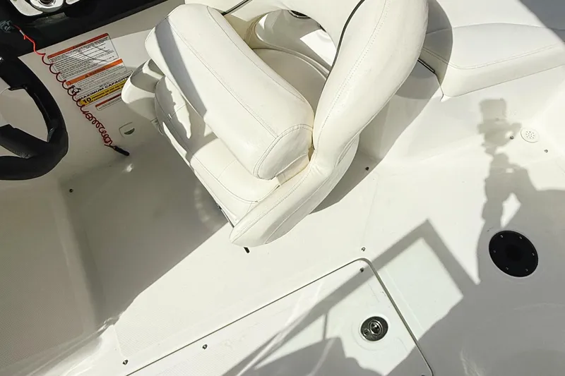 Slide: The Image of 2010 Seadoo 210 Challenger SE boat interior with white seating and steering wheel. - 10