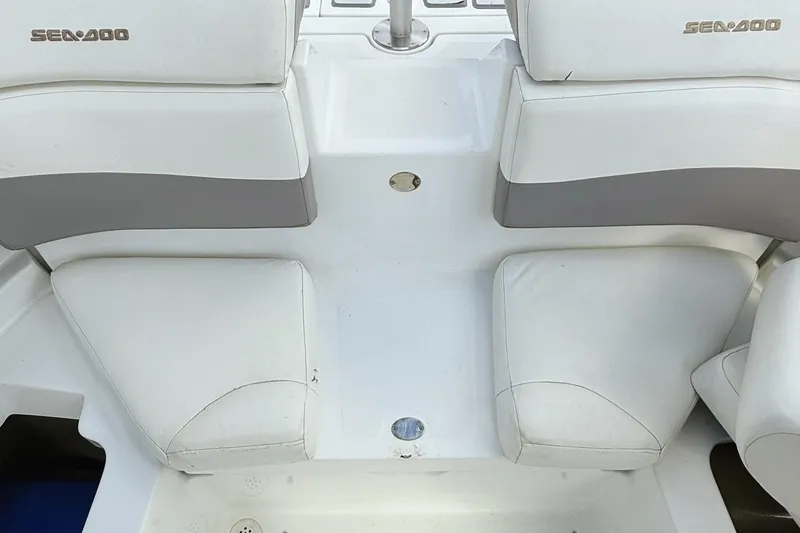 Slide: The Image of 2010 Seadoo 210 Challenger SE boat interior with white and gray seating. - 11