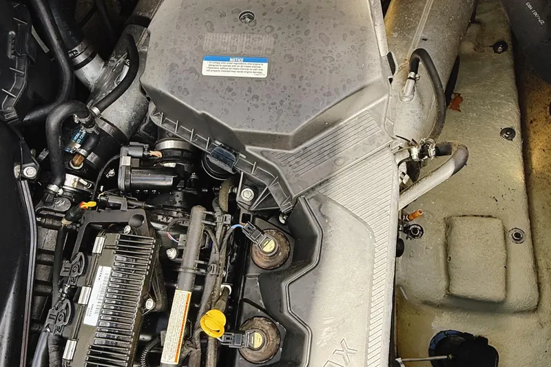 Slide: The Image of Engine compartment of a 2010 Seadoo 210 Challenger SE boat, showing detailed components. - 13